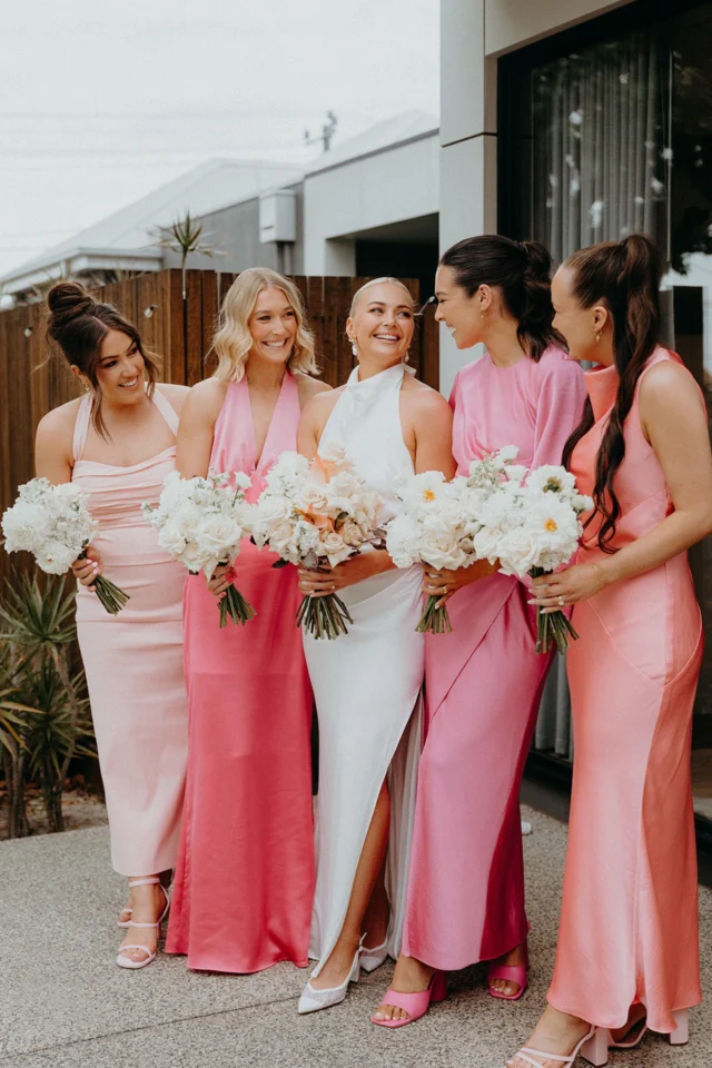 We had the pleasure of working with Tori and Sam to bring their dream nuptials to life last season, and let us tell you – their chosen colour palette was nothing short of spectacular! 
*
The goal was to ensure that the bridal party outfits harmonised beautifully with the florals, so they chose gorgeous En Masse bouquets in all-white, which provided a striking contrast to the delicate pink of the bridesmaids' dresses. This clever pairing allowed both the dresses and the bouquets to shine, ensuring that each element had its moment in the spotlight.
*
We also paid special attention to the groom and groomsmen’s accessories. Our classic white and green buttonholes complemented Sam's sharp black suit and the crisp white shirts of the groomsmen perfectly.
*
*
*
Photography @ryalsormaz
Florals @elderberryevents_
